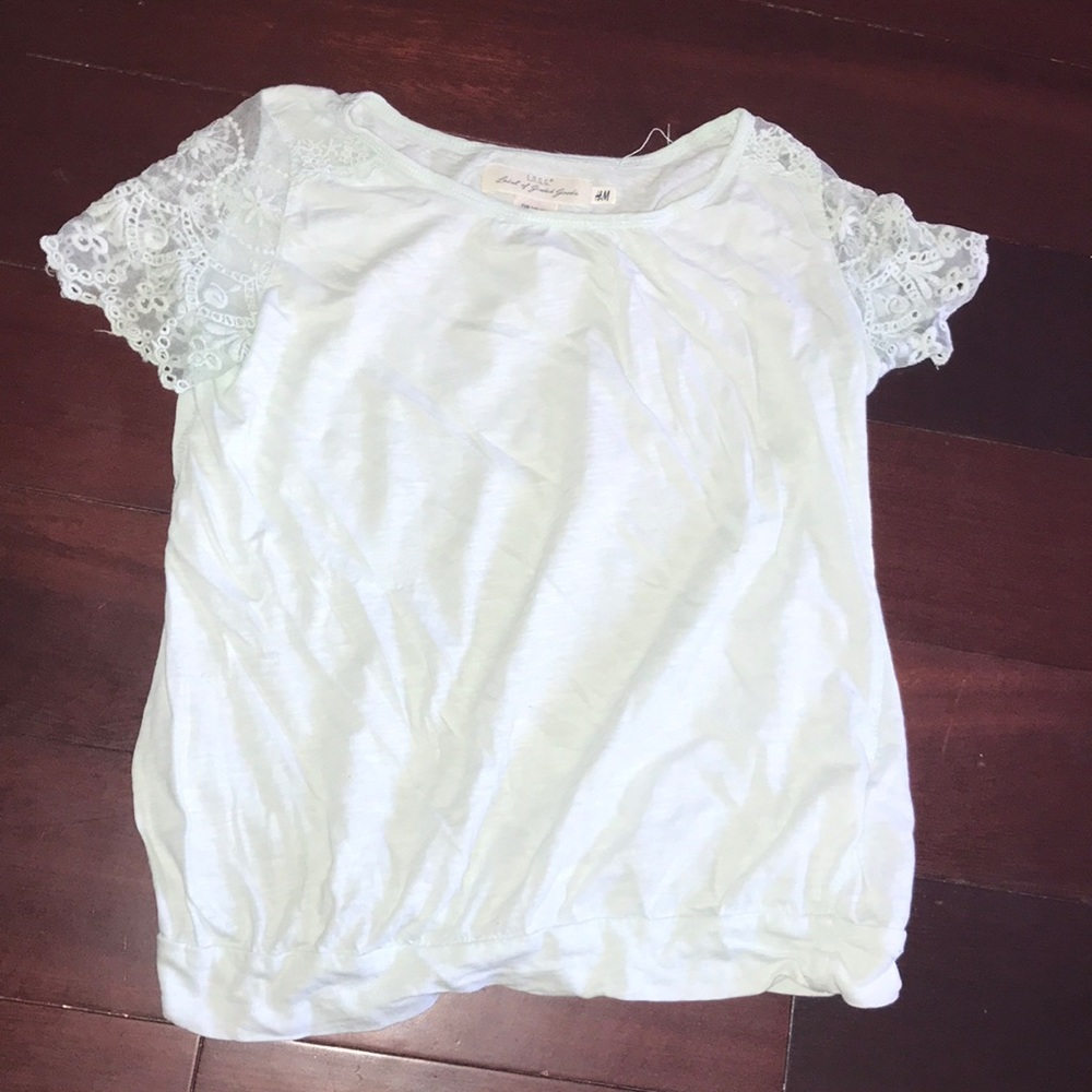 A pastel blue t-shirt with ruffle-like material